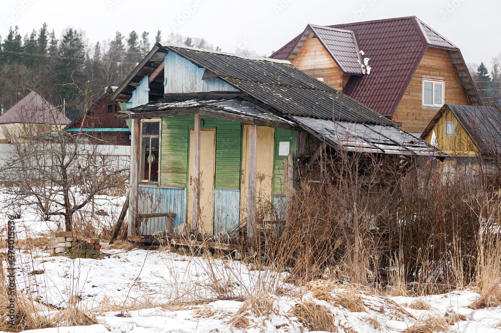 Russian village house next to a spring road