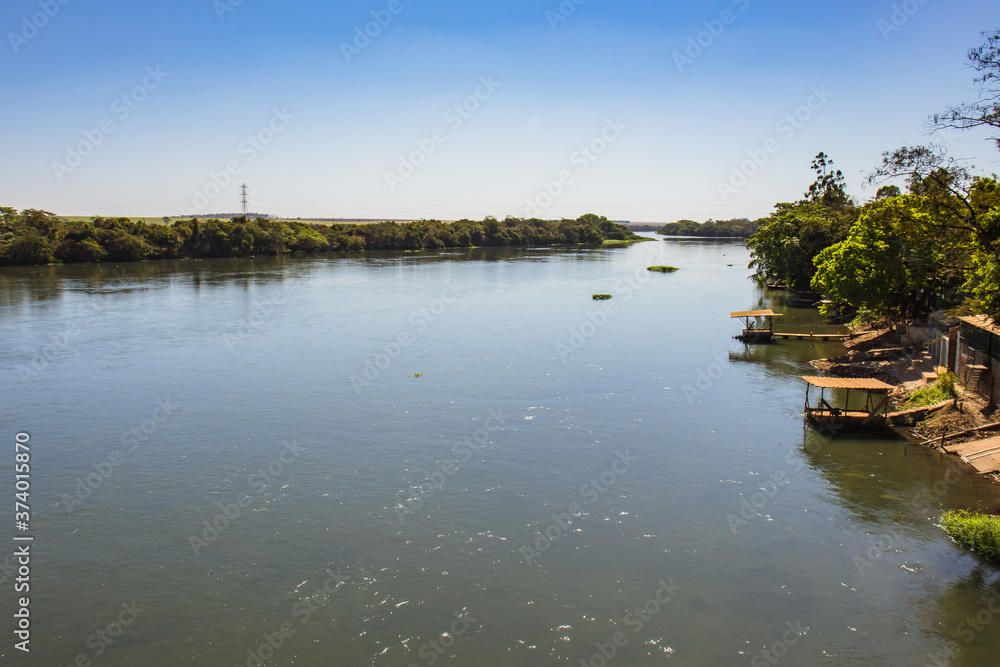 Large river with preserved banks on a sunny day - Rio Pardo - Barretos - Guaíra - São Paulo - Brazil