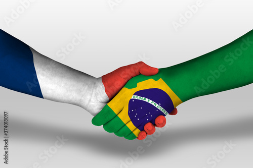 Картината върху платно Handshake between brazil and france flags painted on hands, illustration with clipping path