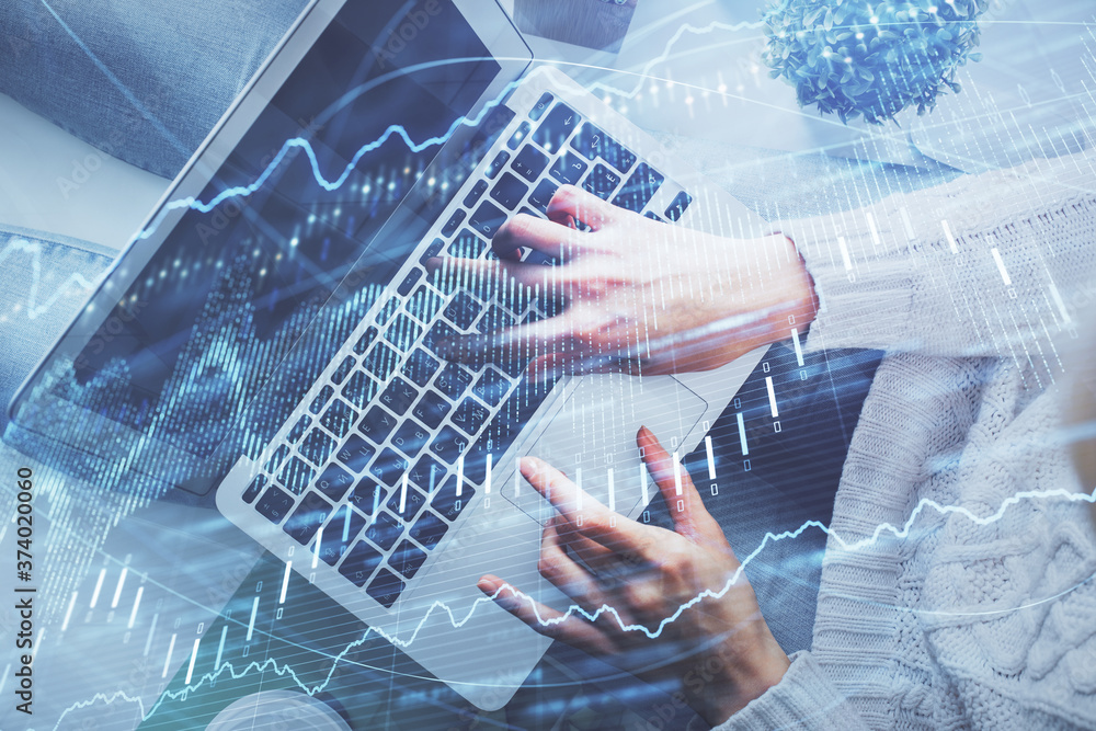 Double exposure of woman hands working on computer and forex chart hologram drawing. Top View. Financial analysis concept.