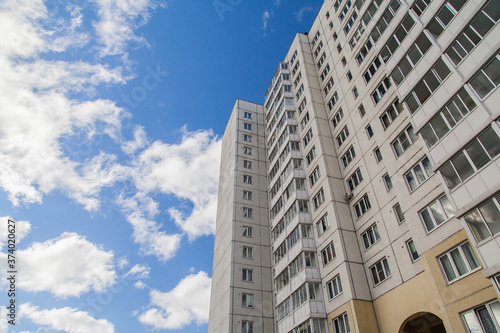 Panel apartment building on the background of the cloudy sky
