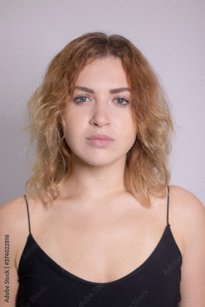 emotional portrait of a beautiful curly blonde-redhead in black undershirt. High quality photo emotional portrait of a beautiful curly blonde-redhead in black undershirt. High quality photo