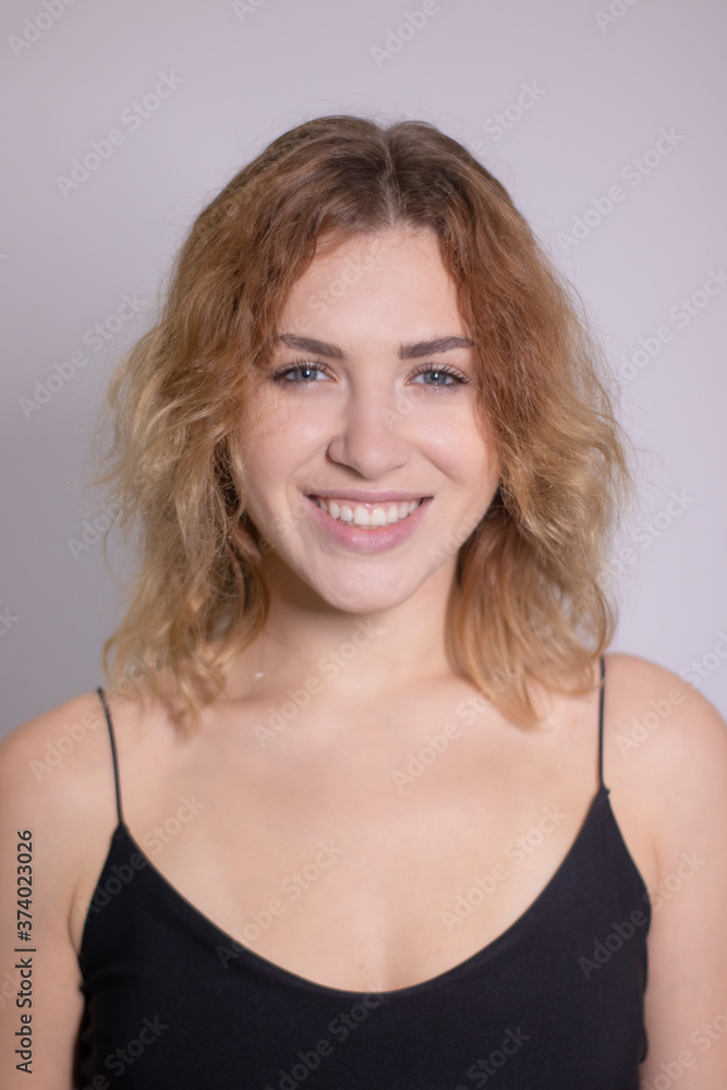 emotional portrait of a beautiful curly blonde-redhead in black undershirt. High quality photo emotional portrait of a beautiful curly blonde-redhead in black undershirt. High quality photo