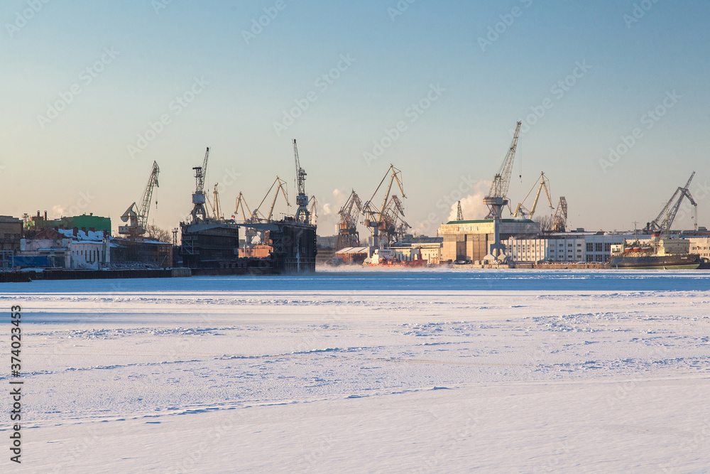 Large industrial cranes of the admiralty shipyards in saint petersburg in winter