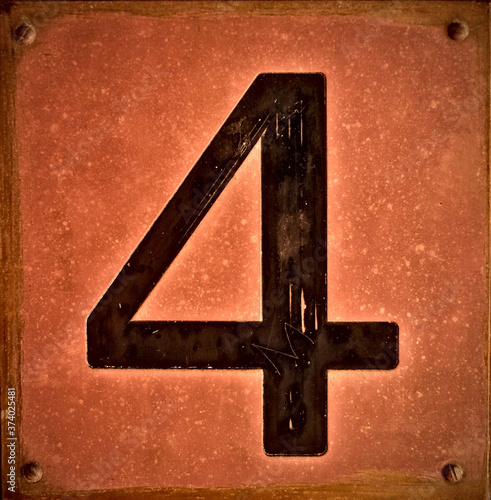 Big bold black number 4, four, on vintage copper background. photo