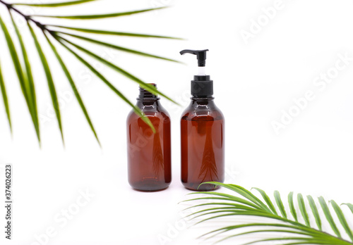 bottle of essential oil with green leaf