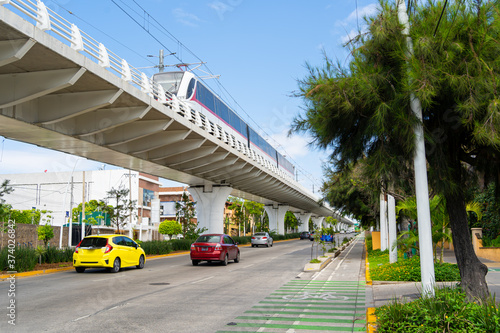 El tren de la línea 3 del tren ligero está circulando sobre la avenida Avila Camacho de Guadalajara. photo
