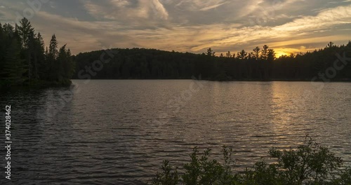 Algonquin Provincial Park Ontario Canada. Sunset time lapse over Sproule Lake. Includes 4 versions - 1 stationary, 1 tilt up, 1 pan right, 1 cropped in to 100%.