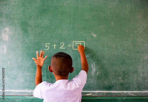 Students doing math exercises on the blackboard