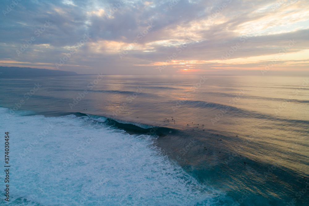 Aerial view of Sunset and waves crashing on North Shore of Oahu, Hawaii