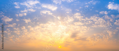 Beautiful Vivid sky painted by the sun leaving bright golden shades.Dense clouds in twilight sky in winter evening.Image of cloud sky on evening time.Evening Vivid sky with clouds.