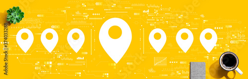Map pin concept with a cup of coffee and a notebook