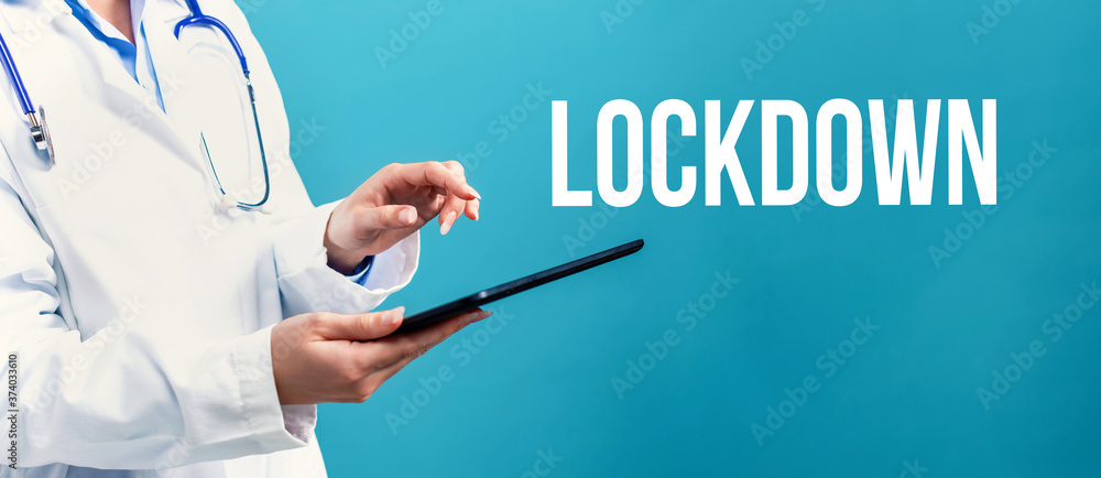 Covid-19 Lockdown theme with a doctor using a tablet computer Covid-19 Lockdown theme with a doctor using a tablet computer