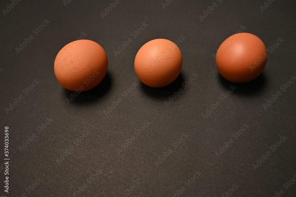 Three chicken eggs isolated on black background Three chicken eggs isolated on black background