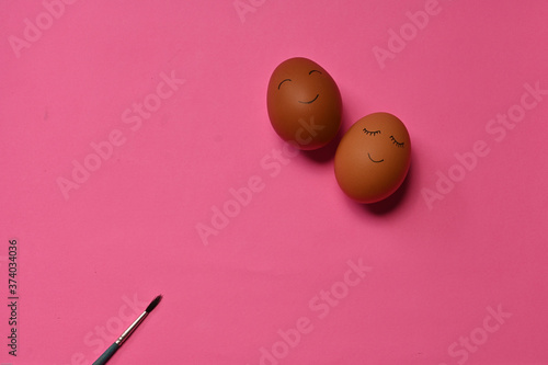 The eggs painted with smile emoticon isolated on colorful background