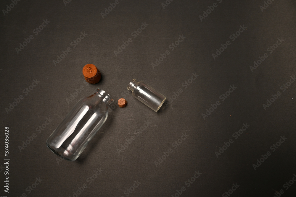 Small transparent glass bottles isolated on black background Small transparent glass bottles isolated on black background