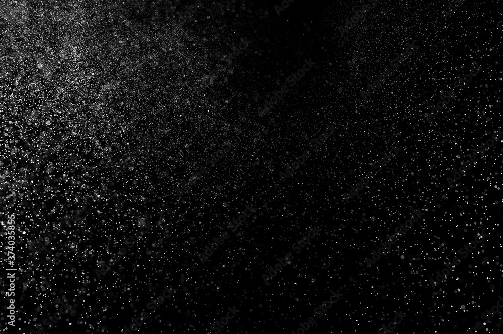 Abstract splashes of water on black background. Freeze motion of white particles. Rain, snow overlay texture. Abstract splashes of water on black background. Freeze motion of white particles. Rain, snow overlay texture.