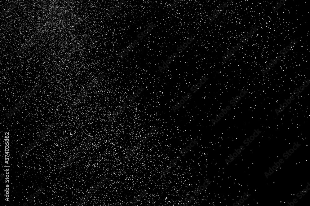 Fototapeta premium Abstract splashes of water on black background. Freeze motion of white particles. Rain, snow overlay texture.
