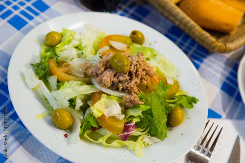 Ensalada manchega, traditional spanish salad with greens, tomatoes, olives and canned tuna