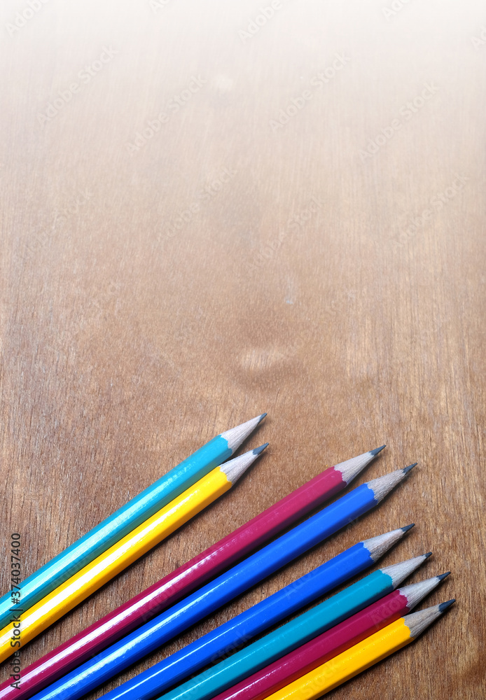colored pencils on vertical wooden background. colored pencils on vertical wooden background.
