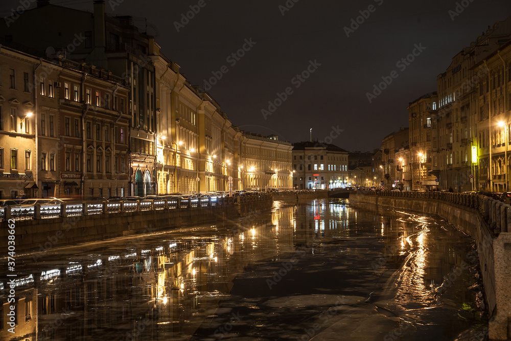 Moika river night cityscape in time of ice drift