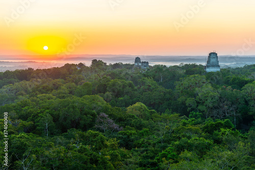 Sunrise in the Peten rainforest with Maya temple pyramids  Tikal  Guatemala.