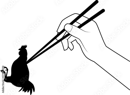 箸でつままれる鶏