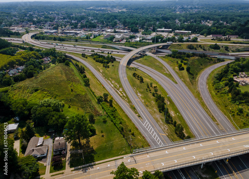 High above highways and interchanges the roads band and the interstate takes you on a fast transportation highway in Cleveland Ohio drone view