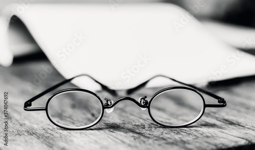 Vintage glasses isolated on the old wooden table with copy space for your text.