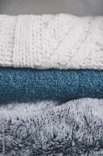 winter lifestyle concept, soft and fluffy blankets and throws stack