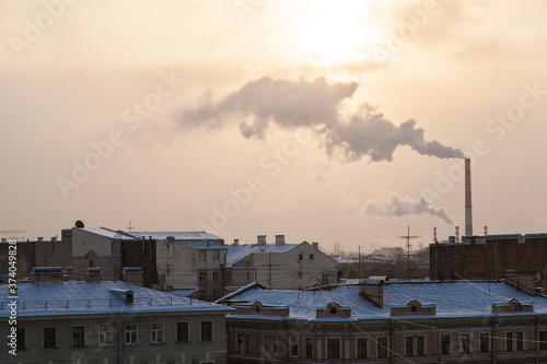 Rooftop cityscape of Saint Petersburg in winter time with smoking factory tubes