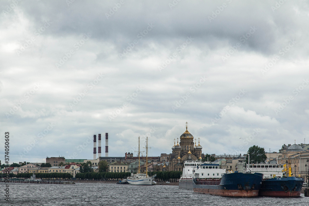 Vasilievskiy island cloudy cityscape. Neva river embankment