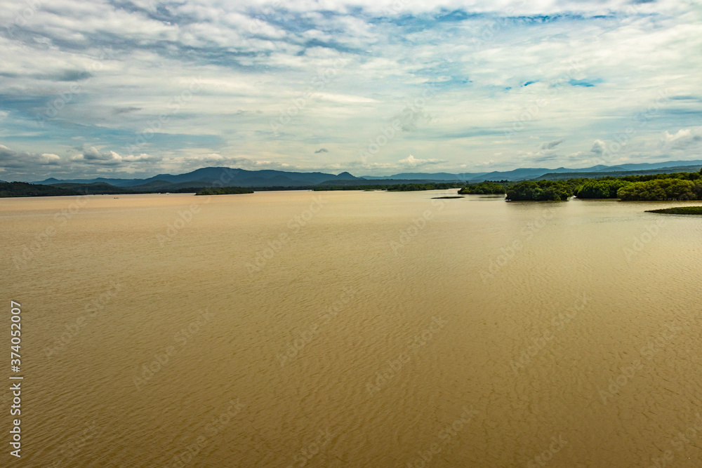 river backwater with mangrove forest and bright sky river backwater with mangrove forest and bright sky