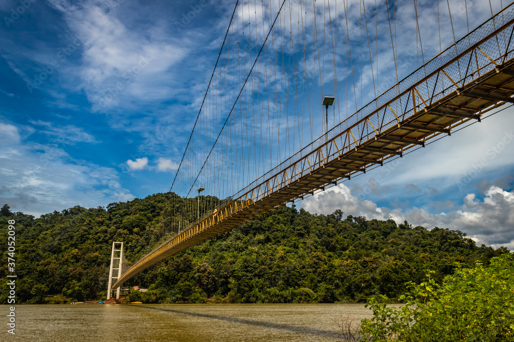 suspension iron bridge isolated with bright blue sky from unique different angle suspension iron bridge isolated with bright blue sky from unique different angle