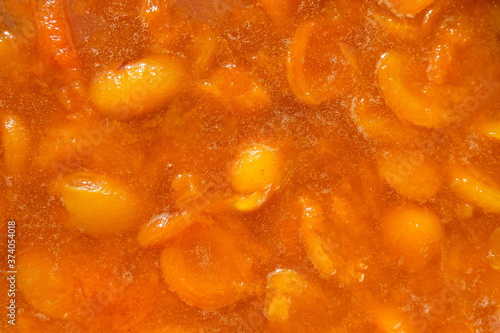 Texture, background of apricot jam. Orange fruit. Home-made for the winter. The view from the top.