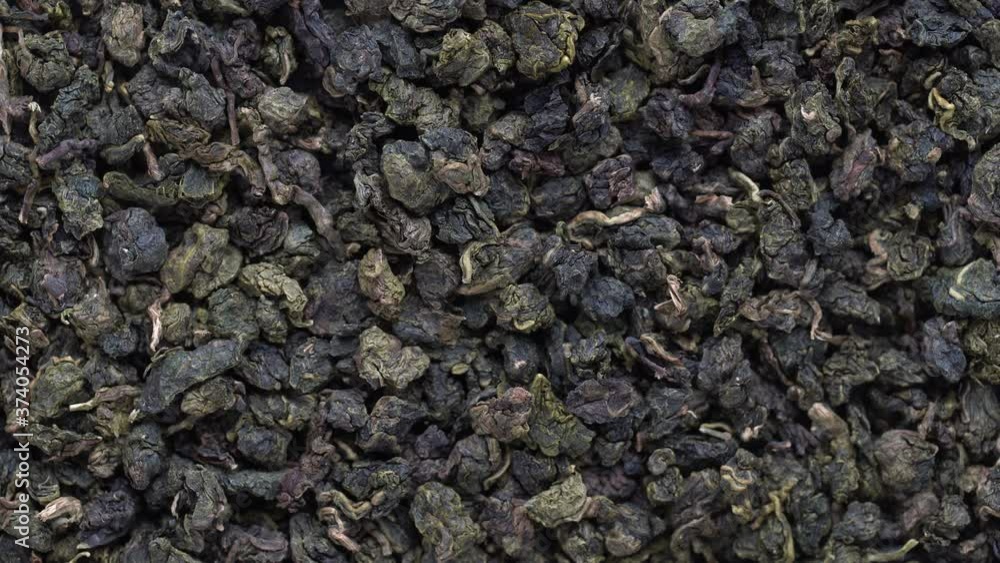 Green tea leaves background. Oolong tea rotates. Abstract food textures. Close up, top view. The high end tea of Vietnam Green tea leaves background. Oolong tea rotates. Abstract food textures. Close up, top view. The high end tea of Vietnam
