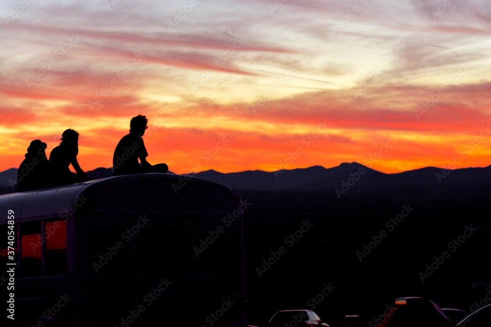 silhouette of a man sitting on a rock