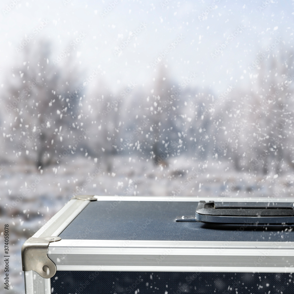 The photographer's suitcase on a winter background with a free space for an advertising product The photographer's suitcase on a winter background with a free space for an advertising product
