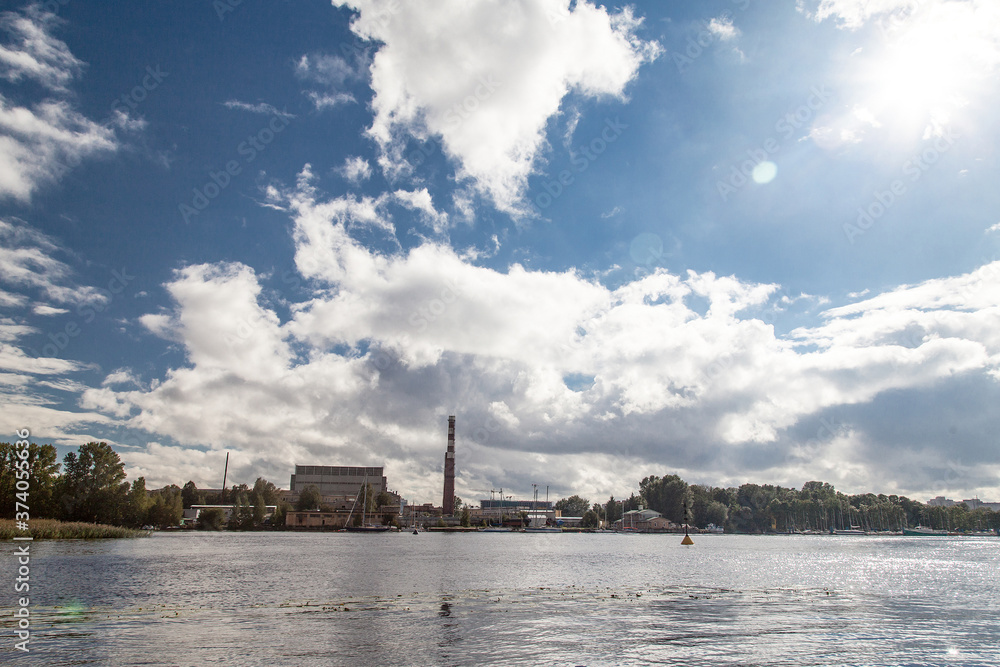 Naklejka premium River cityscape with old factory in sunny day