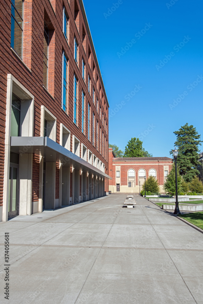 Public university campus on sunny day showing new and old architecture and open spaces with no college students present. Public university campus on sunny day showing new and old architecture and open spaces with no college students present.