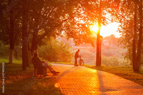 Sunset silhouette of man with bicycle