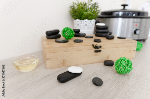 Hot stone massage. Close up pile of spa stones with aroma oil still life 