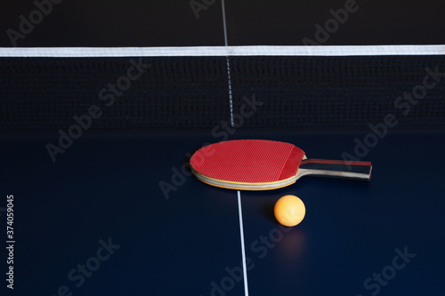 Table tennis racket, ball, and net for table tennis.