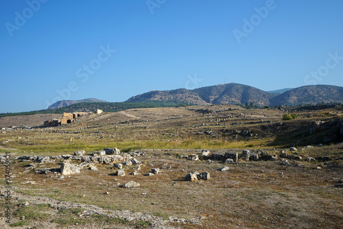 Exterior architecture and ancient design of Hierapolis and Pamukkale national park, town in western Turkey known as mineral-rich thermal waters flowing down white travertine terraces on hillside