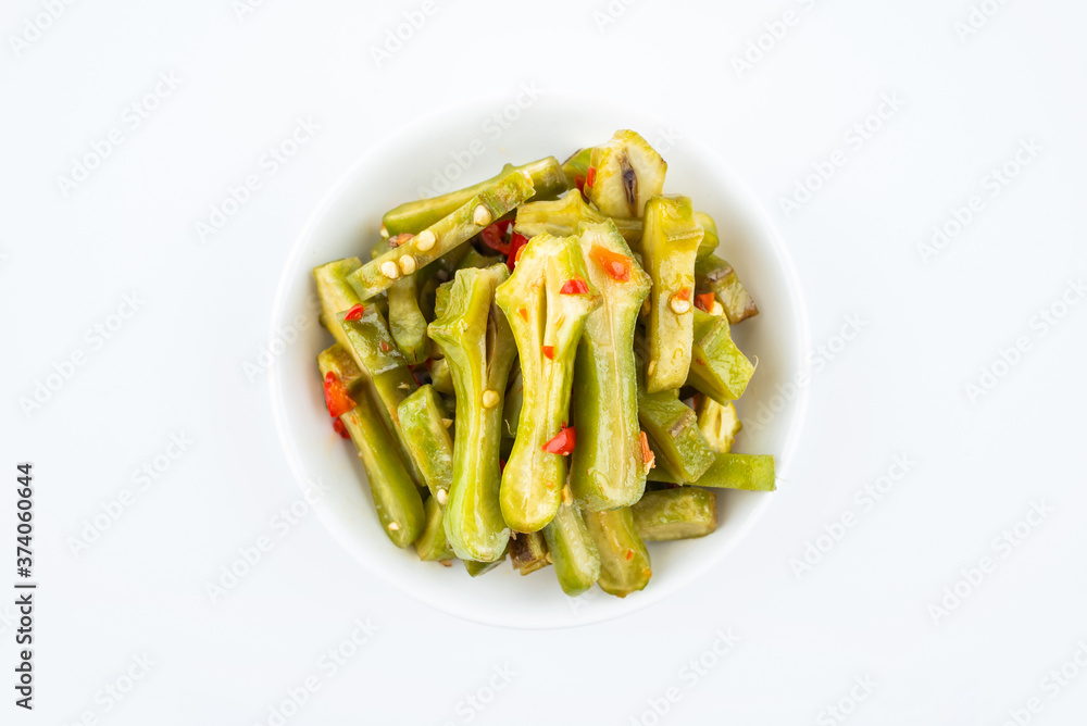 A dish of Chinese Hunan cuisine pickled beans on a white background