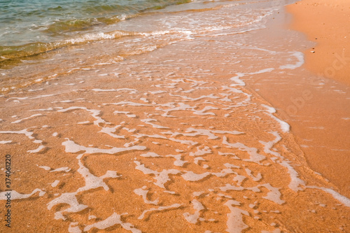 Tourist travel banner design template, copy space. White foam of a sea wave, golden sand beach, turquoise ocean water.