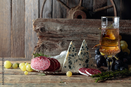 Rustic still life with wine and snacks.