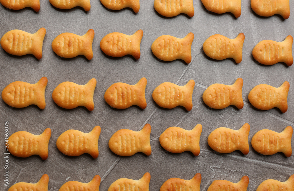 Delicious goldfish crackers on grey table, flat lay Delicious goldfish crackers on grey table, flat lay