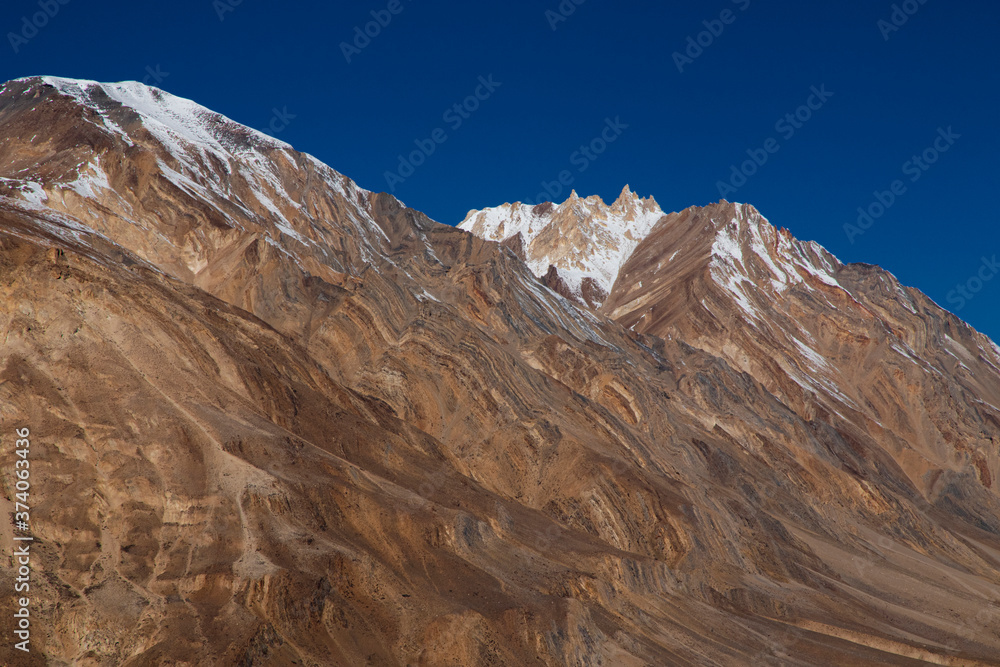 Texture of Spiti hills with snow on a clear day