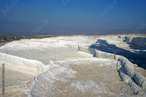 Natural landscape and Thermal pools of Pamukkale  Cotton castle  mineral-rich thermal waters flowing down white travertine terraces on a nearby hillside formed by ancient hot springs- Denizli  Turkey